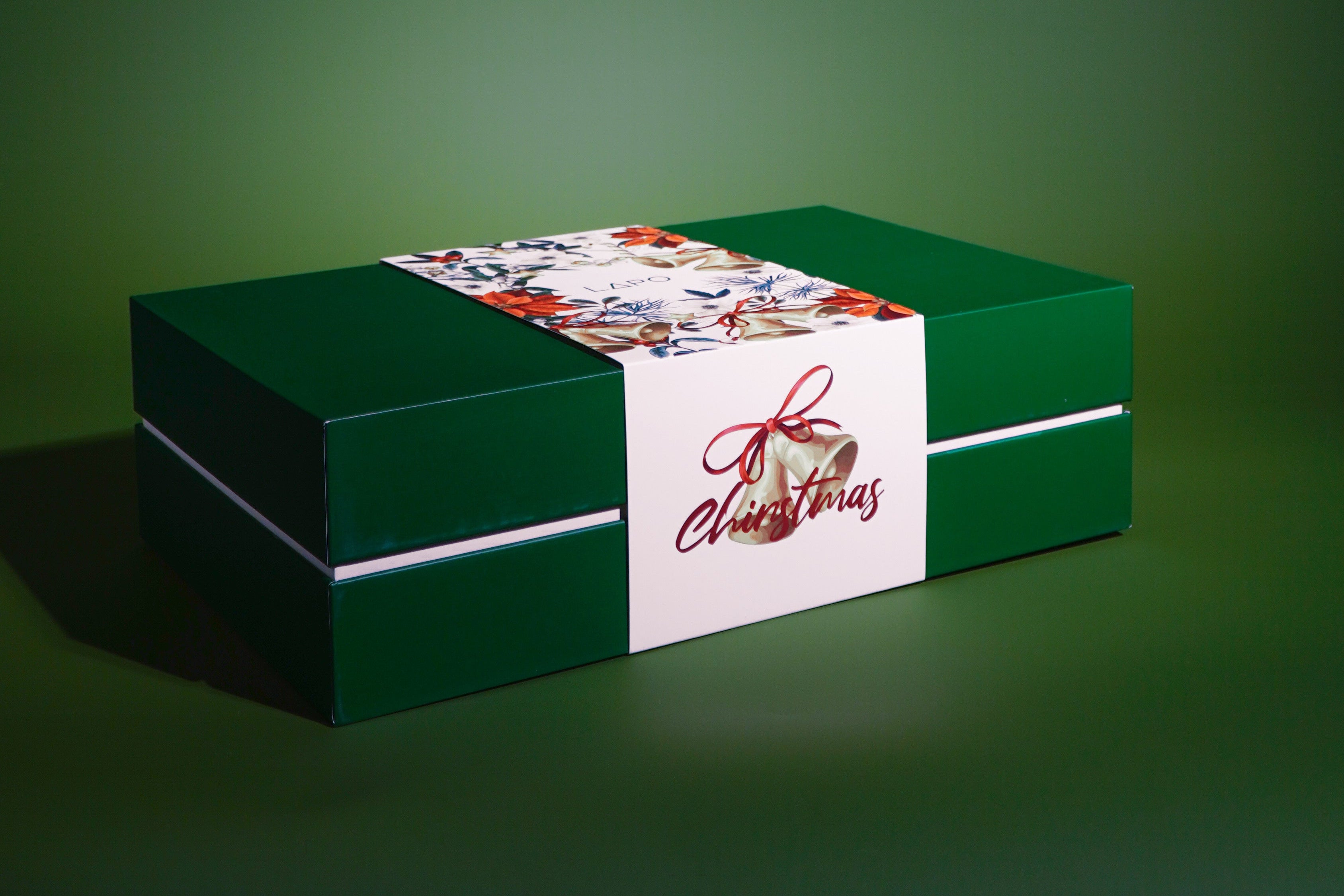 Green gift box with a white label on a green background