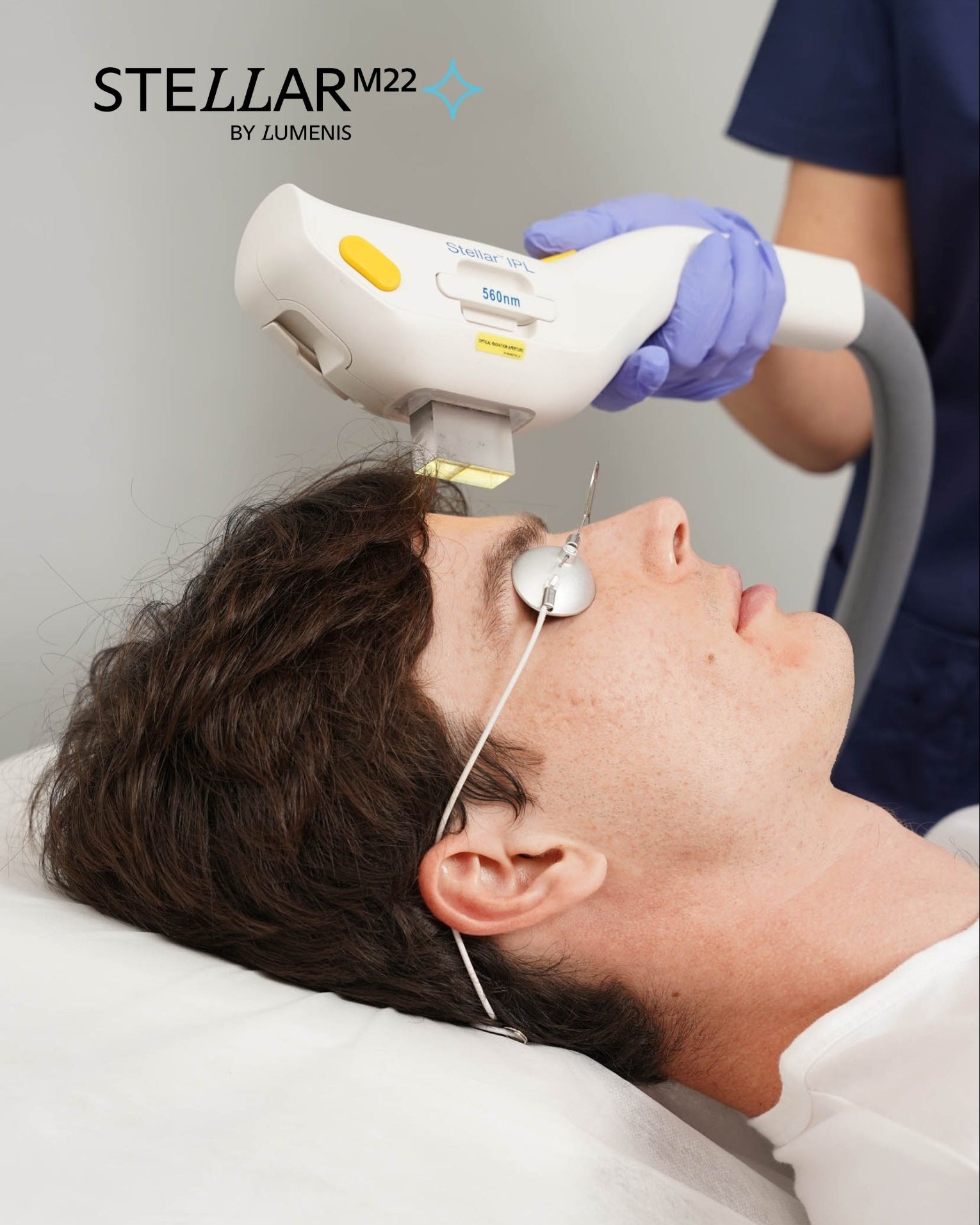 Person receiving a facial treatment with Stellar M22 device, branded by Luminis.