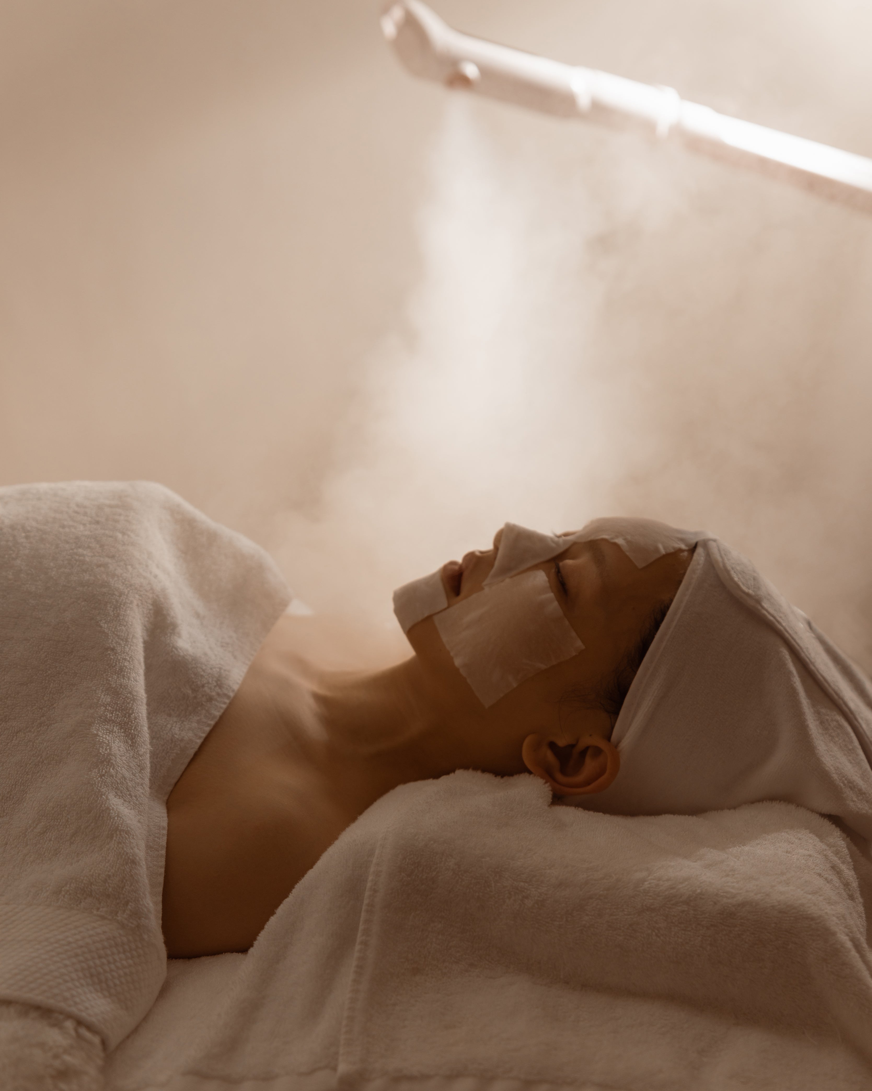 Person lying in bed with Ozone steam.